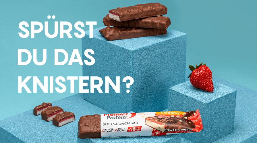 Chocolate protein bars on a blue geometric background with a strawberry.