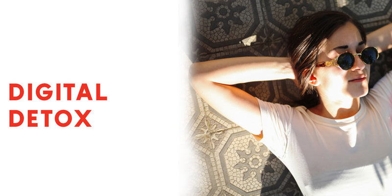 Person wearing sunglasses lying on a patterned rug with 'Digital Detox' text.