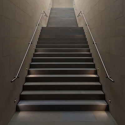 Staircase with metal handrails in a modern building interior.