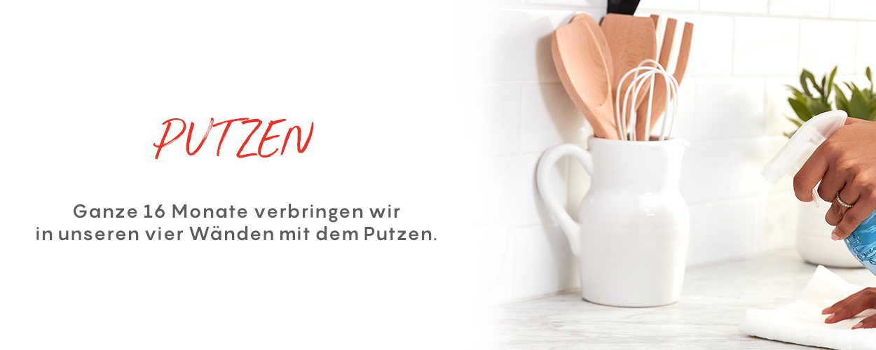 White mug with kitchen utensils on a white surface, with text 'PUTZEN' and German text below.